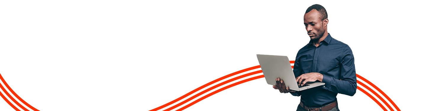 man standing and working on a laptop