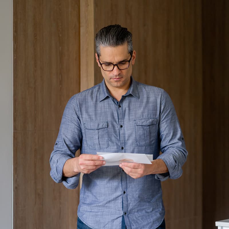 Man looking at a piece of mail