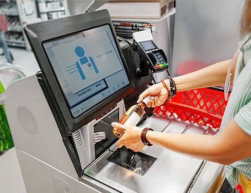 store clerk scanning and item at checkout