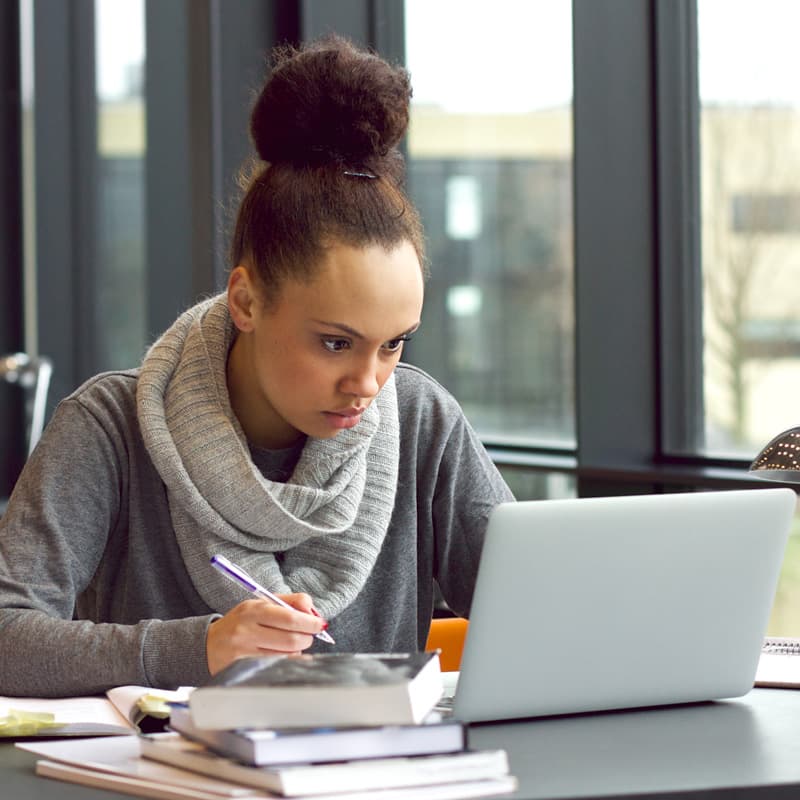 Woman researching at laptop